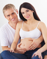 A young and lovely couple: happy man and pregnant woman