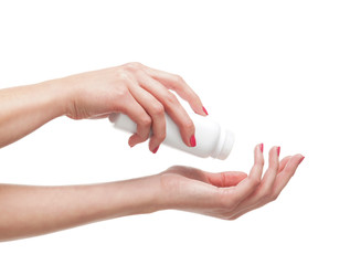 Beautiful female hands with the talcum powder on white