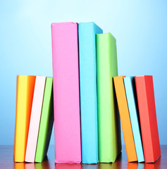 Stack of multicolor books   on blue background