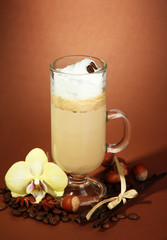 Fragrant coffee latte in glass cup with spices,