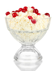 Cottage cheese in  glass bowl with red berries, isolated