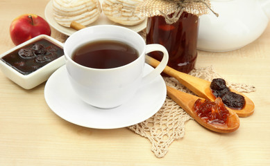 light breakfast with tea and homemade jam, on wooden table