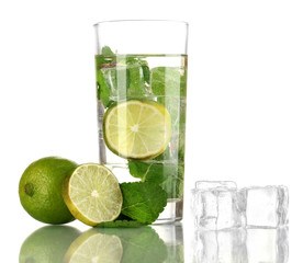 Glass of water with ice, mint and lime isolated on white