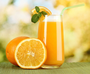 Glass of orange juice with mint and orange