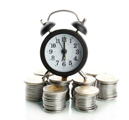 Alarm clock with coins isolated on white