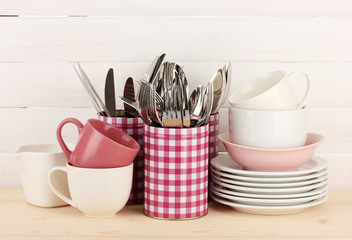 Cups, bowls nd other utensils in metal containers isolated