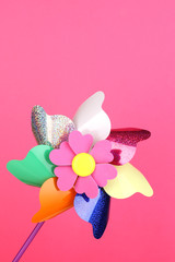 Colored pinwheel on pink background