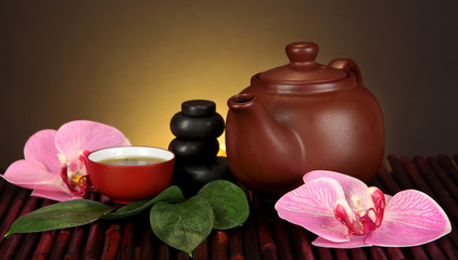 Chinese tea ceremony on bamboo table on brown background