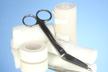 First aid kit for bandaging on blue background