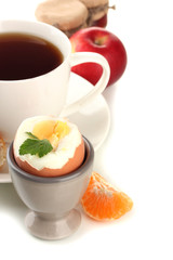 Light breakfast with boiled egg and cup of coffee, isolated