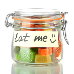 Multicolor candies in glass jar, isolated on white