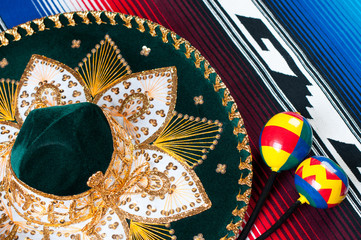 Multi colored mexican poncho, traditional sombrero and maracas