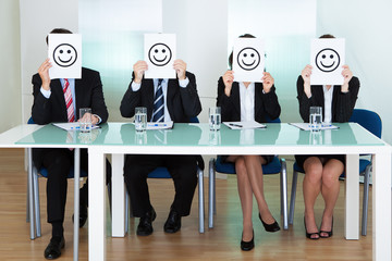 Row of business executives with smiley faces - obrazy, fototapety, plakaty