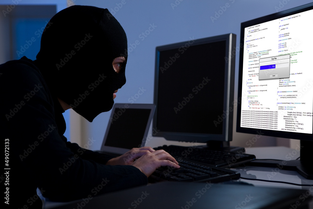 Wall mural hacker downloading information off a computer