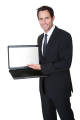 Happy middle aged businessman with laptop