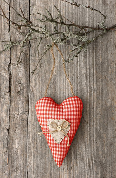 red textile heart on wooden background