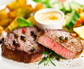 Grilled steak, baked potatoes and vegetables