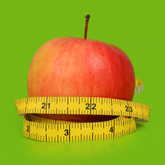 Red apple wrapped with a measuring tape