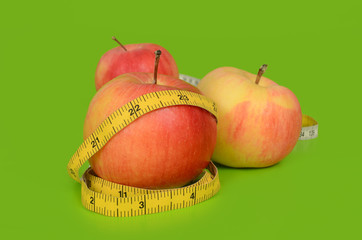 Red apples wrapped with a measuring tape