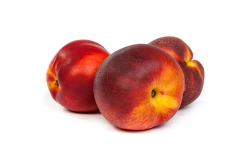 Three fresh nectarines on white