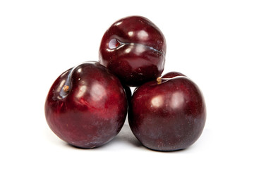 Group of plums  on white