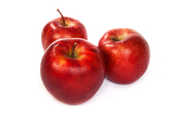 Three shiny red apples isolated on white