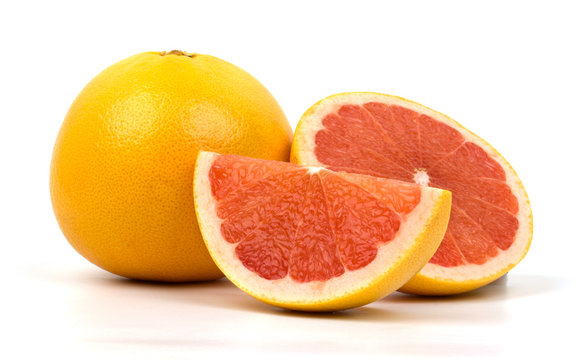 Cut red grapefruit isolated on white background