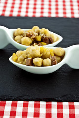 Couple chickpea stew on a slate table mats.