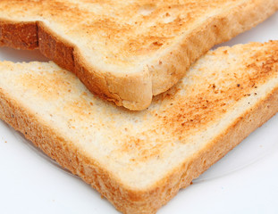 Two pieces of beautiful toast on a white plate