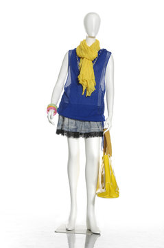 Full female dress with yellow scarf and bag on mannequin