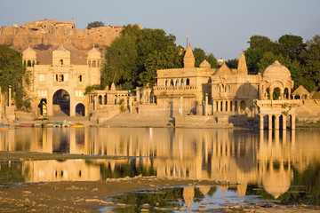 Fototapeta premium Stone tower in sacred Gadi Sagar lake in Jaisalmer, India