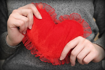 red heart in woman's hands, close-up