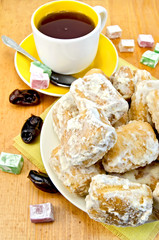 Baursak with tea and oriental sweets on the board