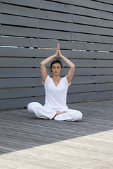 young woman meditating outdoors
