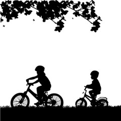 Kids bike ride in park in spring silhouette