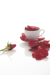 Coffee cup and rose petals