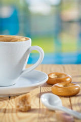 cup spoon sugar and cookie on table