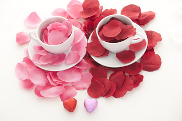 Coffee cup and rose petals