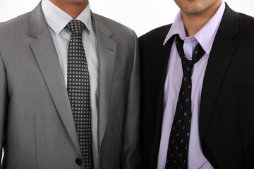 One executive with a perfect tie, another with a loosened tie