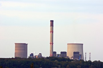 Nuclear power station at dusk with cooling towers