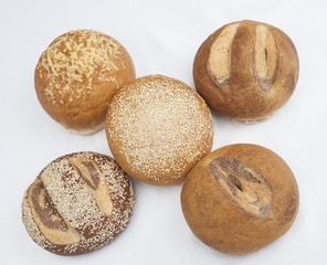 Selection of bread loaves on white