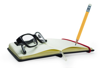 Pencil and black frame glasses on the notebook
