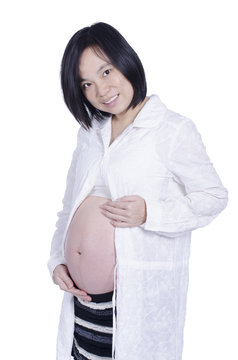 Beautiful pregnant woman isolated over white background