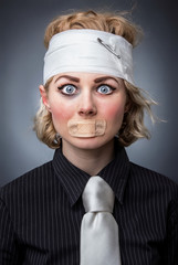 Portrait of a injured woman with adhesive bandage over muoth