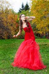 Fototapeta premium A beautiful brunette in red dress