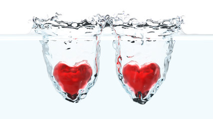 Fototapeta na wymiar Two red hearts falling into water