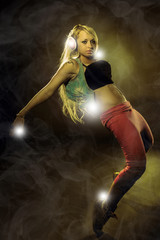 Sexy blonde woman dancing with headphones