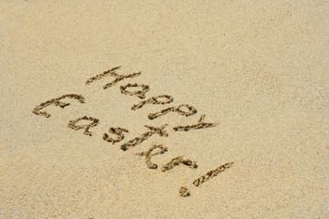 Fototapeta na wymiar Conceptual handwritten text Happy Easter in sand