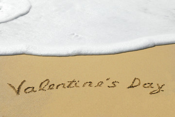 Conceptual handwritten text Valentine`s Day in sand
