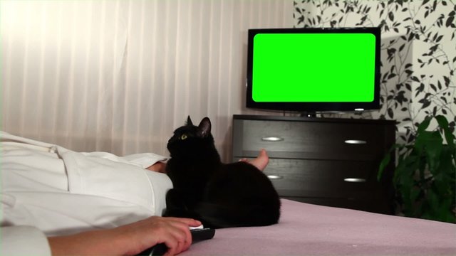 Woman watches green screened TV